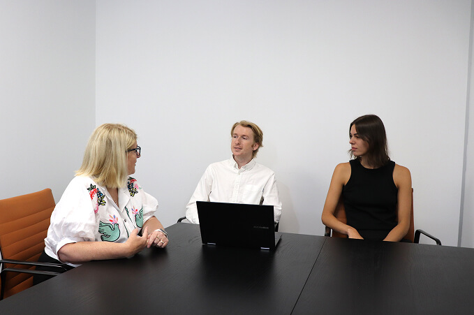 A group of people around a table in a workplace setting